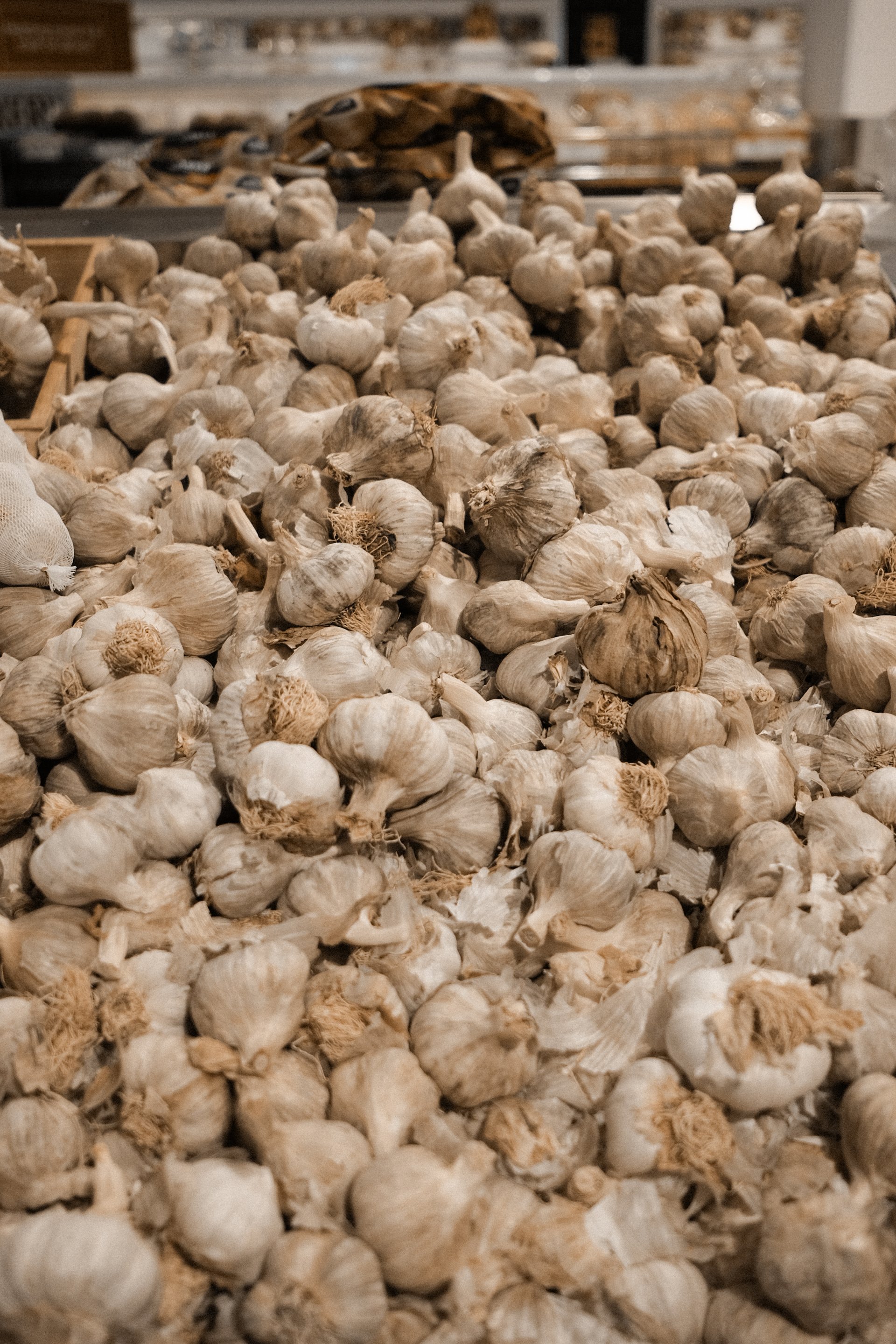 photo of an abundant supermarket stack of garlic heads